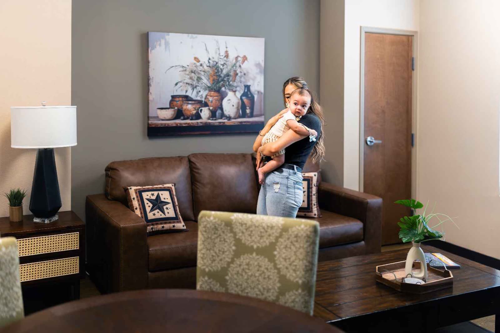 A mother holding her baby in a furnished Cathedral Life Centre residence